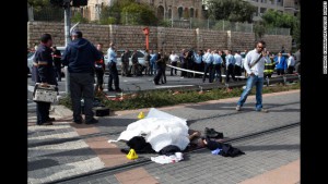 The body of Palestinian attacker lies covered on the rails of Jerusalem's tramway on November 5, 2014 after he was killed when he deliberately rammed his vehicle into a crowd of pedestrians in Jerusalem. One person was killed and at least nine others wounded. Police described the incident as a "hit and run terror attack" and said it took place in the same area as a similar attack two weeks ago, in which a Palestinian rammed a car into a crowd killing a woman and a baby. AFP PHOTO/MENAHEM KAHANA (Photo credit should read MENAHEM KAHANA/AFP/Getty Images)
